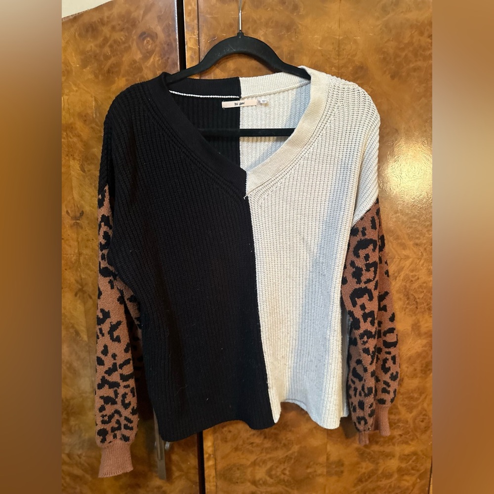 Chic Black and Cream V-Neck Sweater with Leopard Sleeves